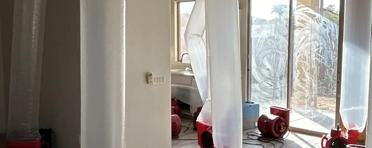 Air movers blowing through ducting tubes to dry a home, the mitigation step that comes before reconstruction