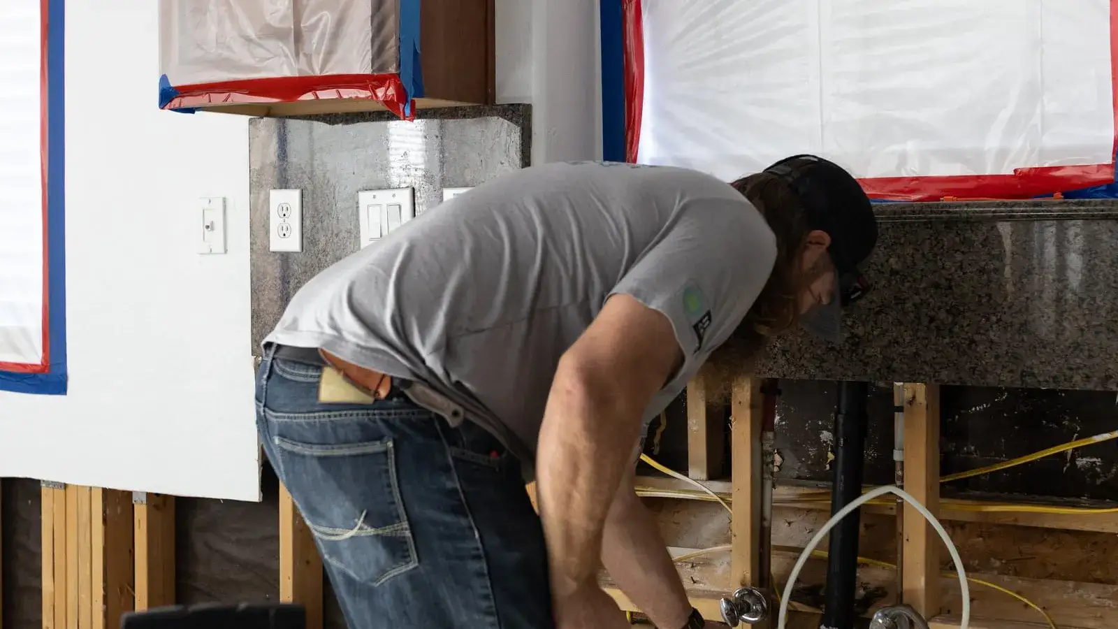 Fast Track technician opening a wall inside a containment to find hidden water damage