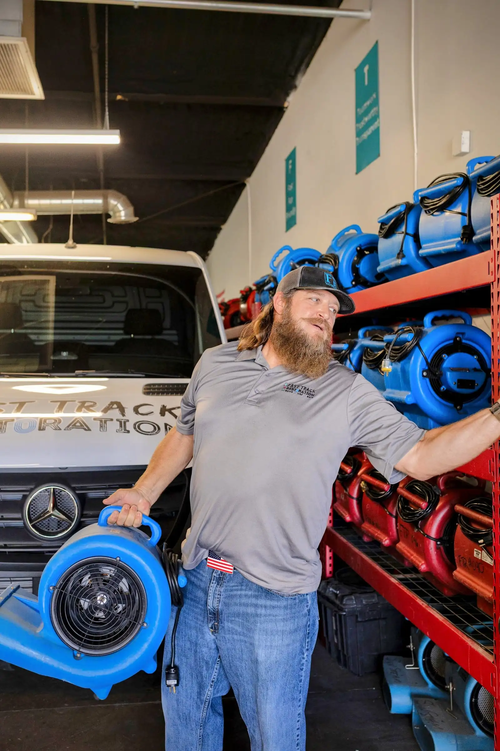 Fast Track technician with an air mover in the company's Mesa equipment warehouse