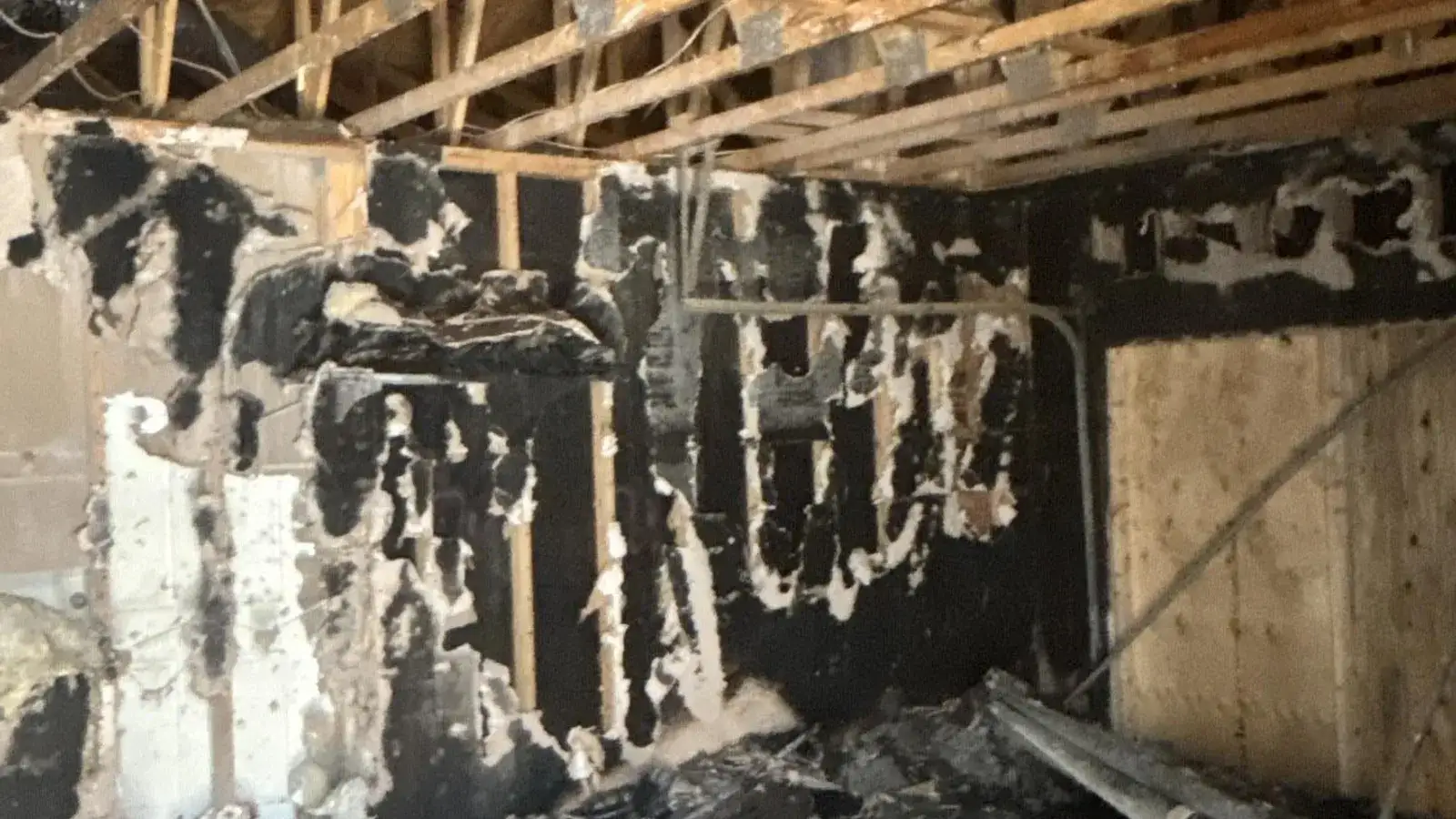 Charred attic framing after a house fire — Fast Track Restoration job photo