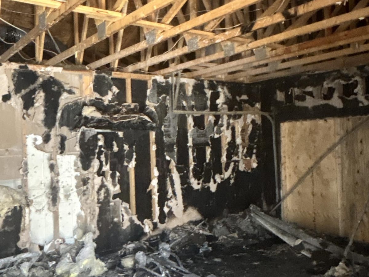 Charred attic framing after a house fire in the East Valley