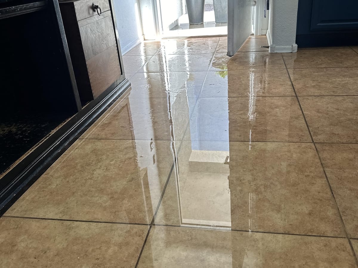 Water covering a tile floor after a plumbing failure