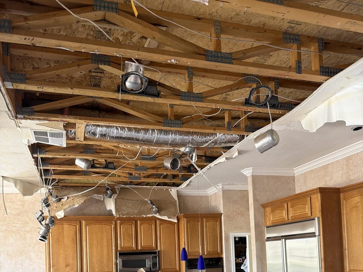 Kitchen ceiling opened up after a roof leak — Fast Track Restoration job photo